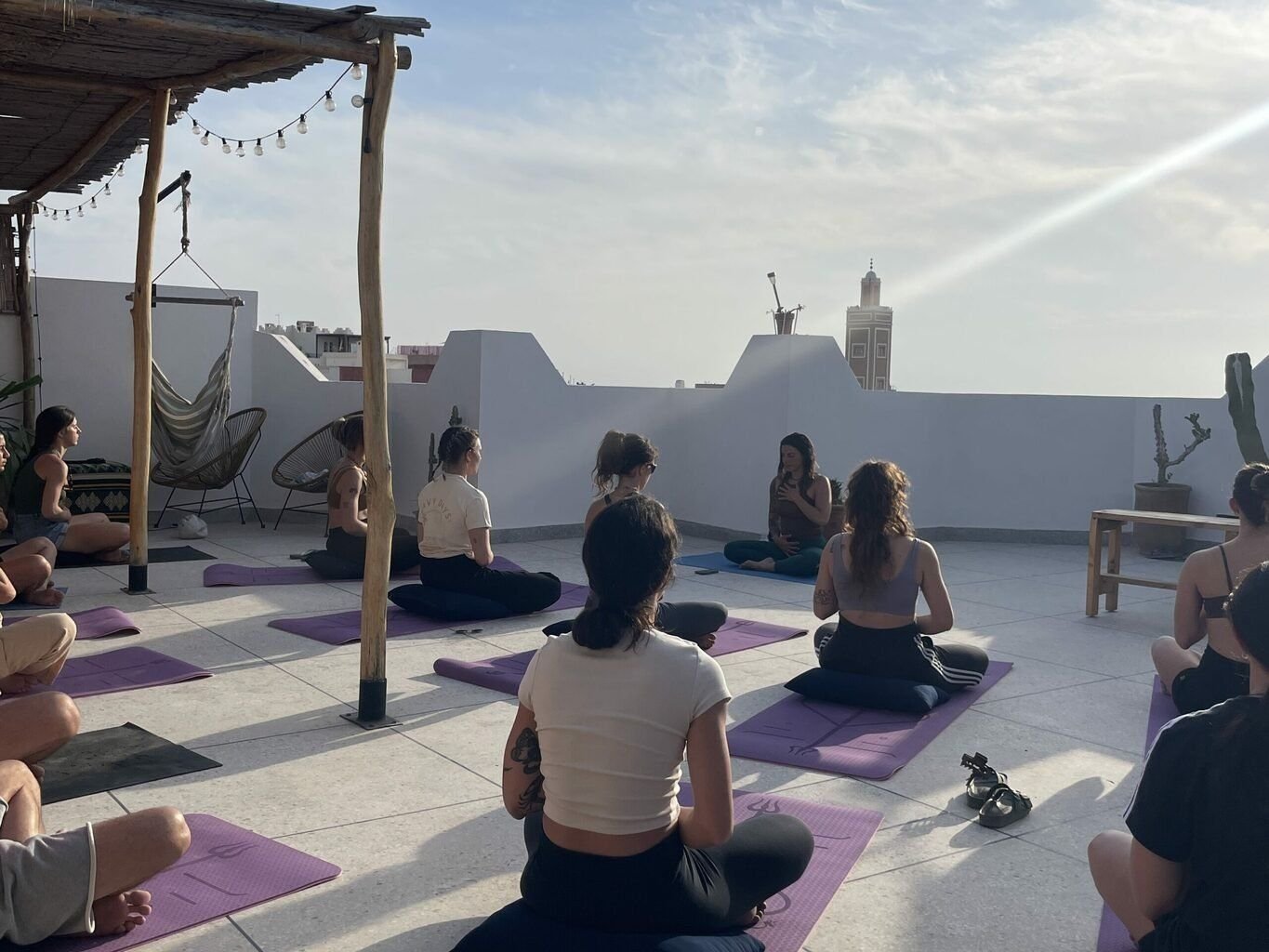 Sunset yoga class on the surf camp rooftop in Taghazout